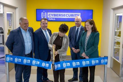 President Toro cuts a ceremonial ribbon at the new Cybersecurity Hall at Central.