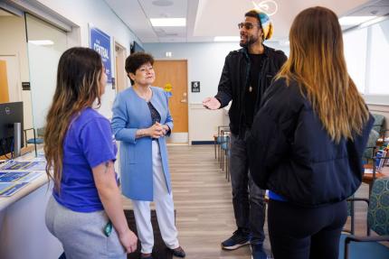 President Toro with students in the health clinic