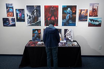 person looking at artwork on gallery wall