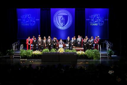 Campus leadership on stage at winter commencement