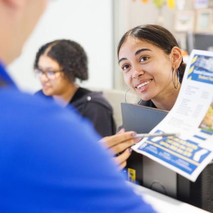 Student in Financial Aid office helping other students