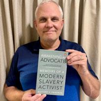 Matt Friedman with book- Memoirs of a Modern Slavery Activist