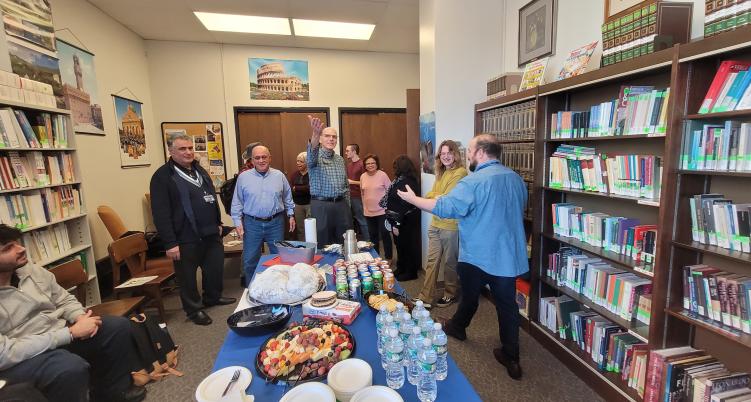 celebratory gathering in a library with food